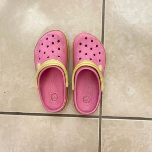 Pink and yellow crocs